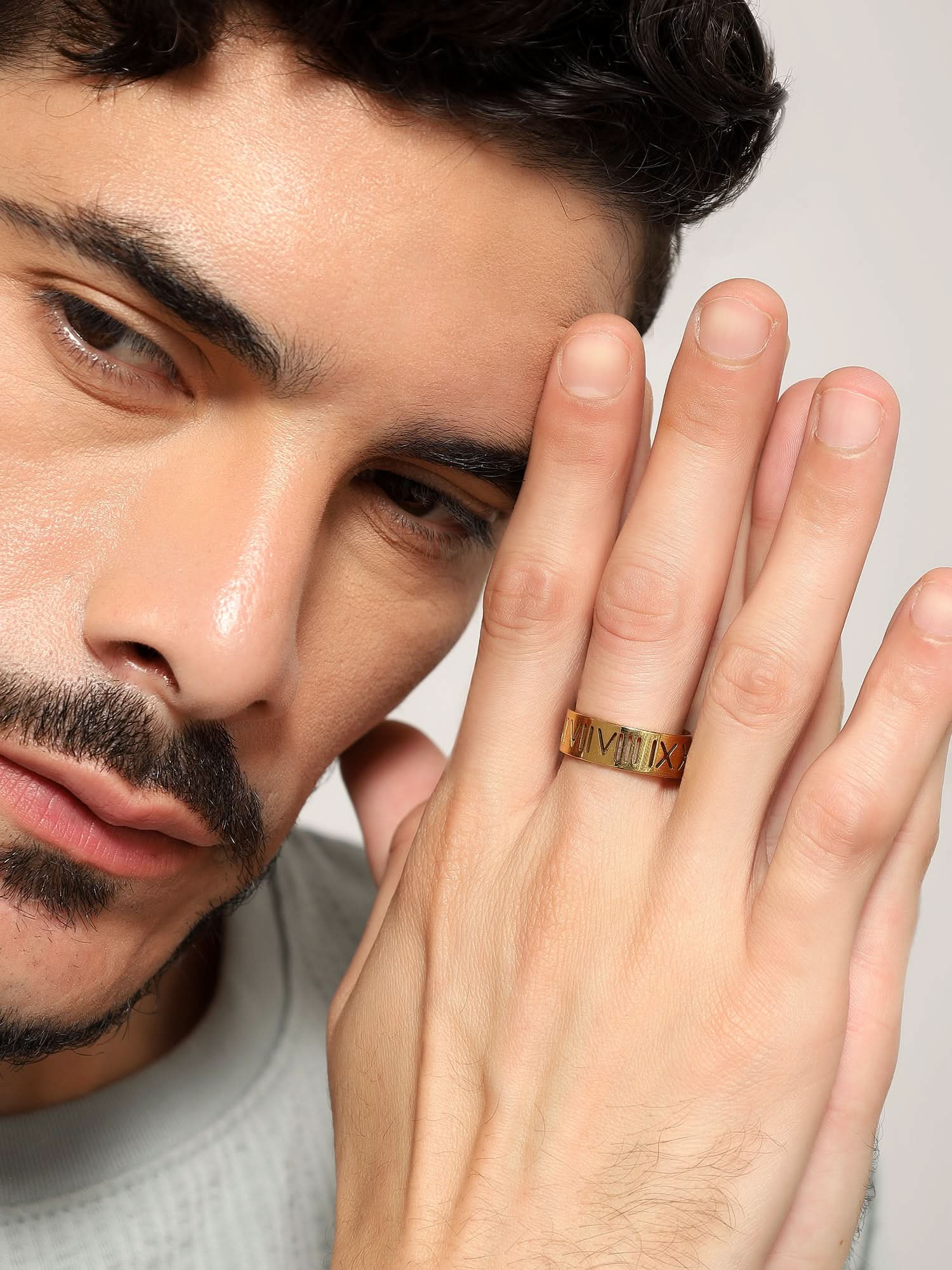 Model wearing Roman Numerals Ring in gold — men's gold ring styled on hand