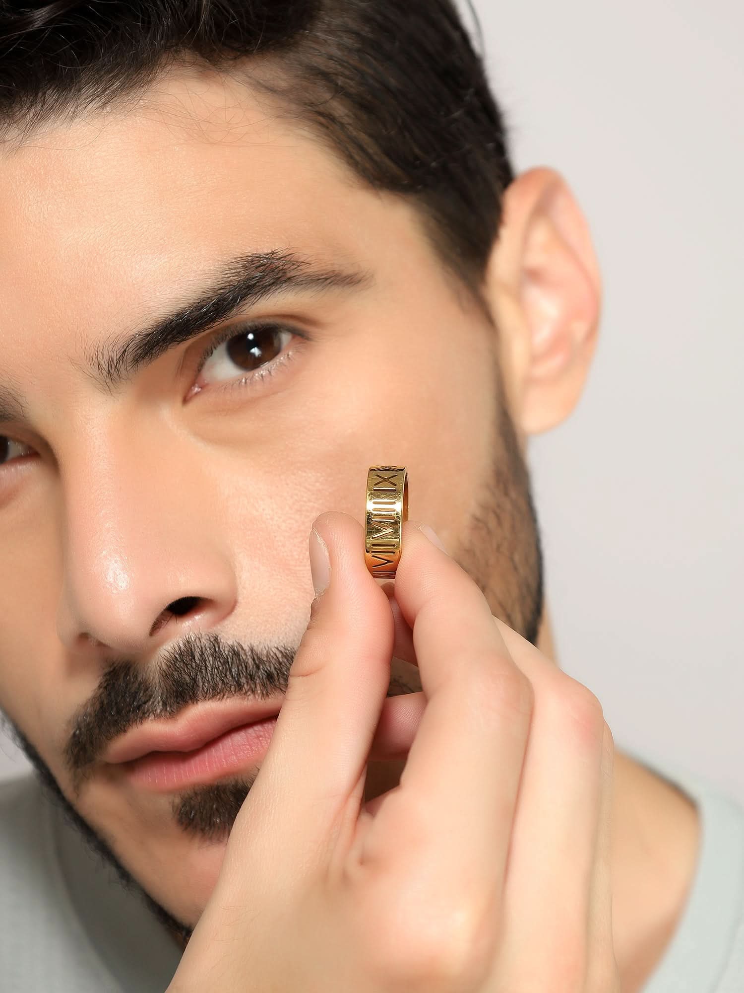 Model wearing Roman Numerals Ring in gold — men's gold ring styled on hand