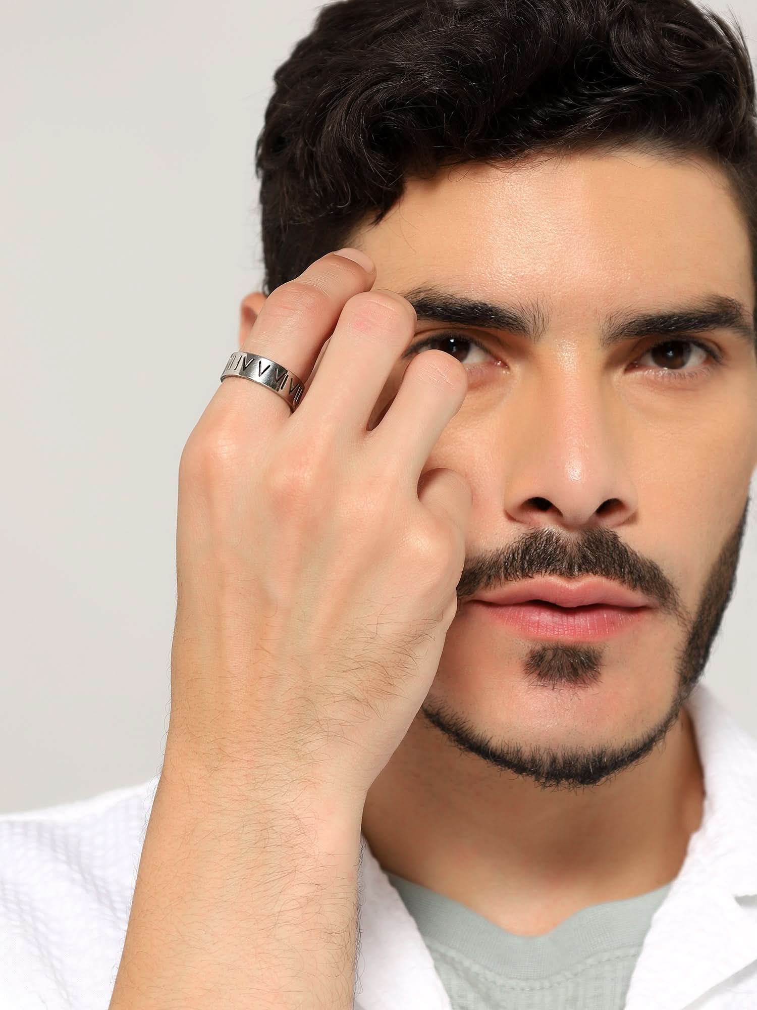 Model wearing Roman Numerals Ring in silver — men's silver ring styled on hand