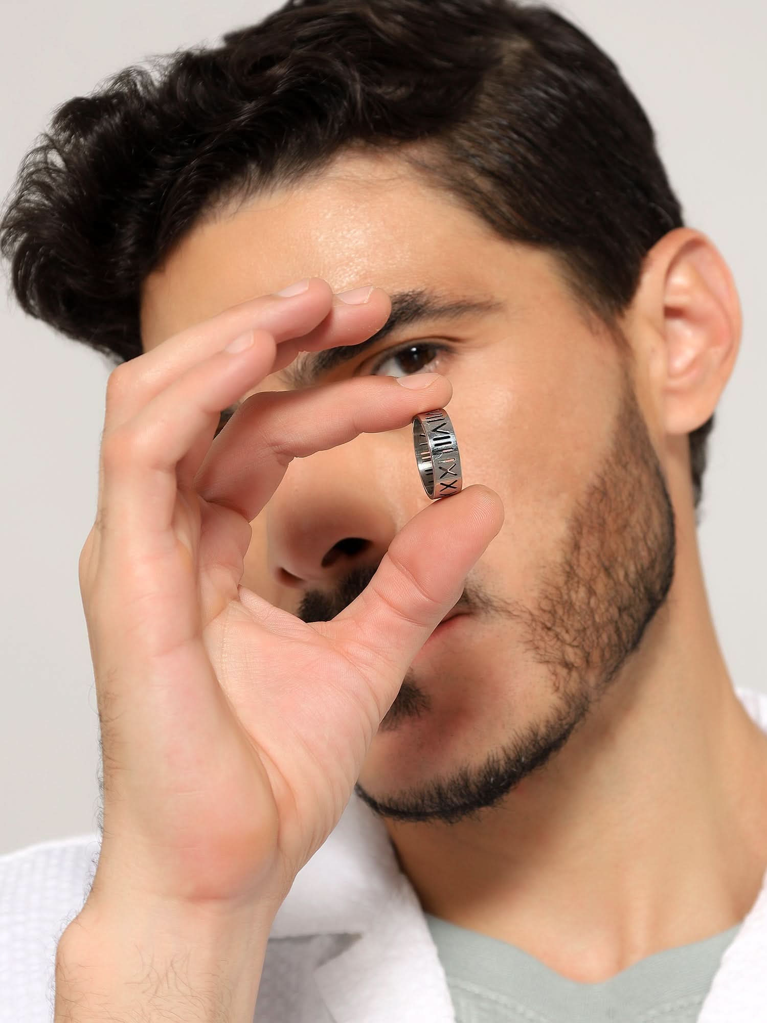 Model wearing Roman Numerals Ring in silver — men's silver ring styled on hand