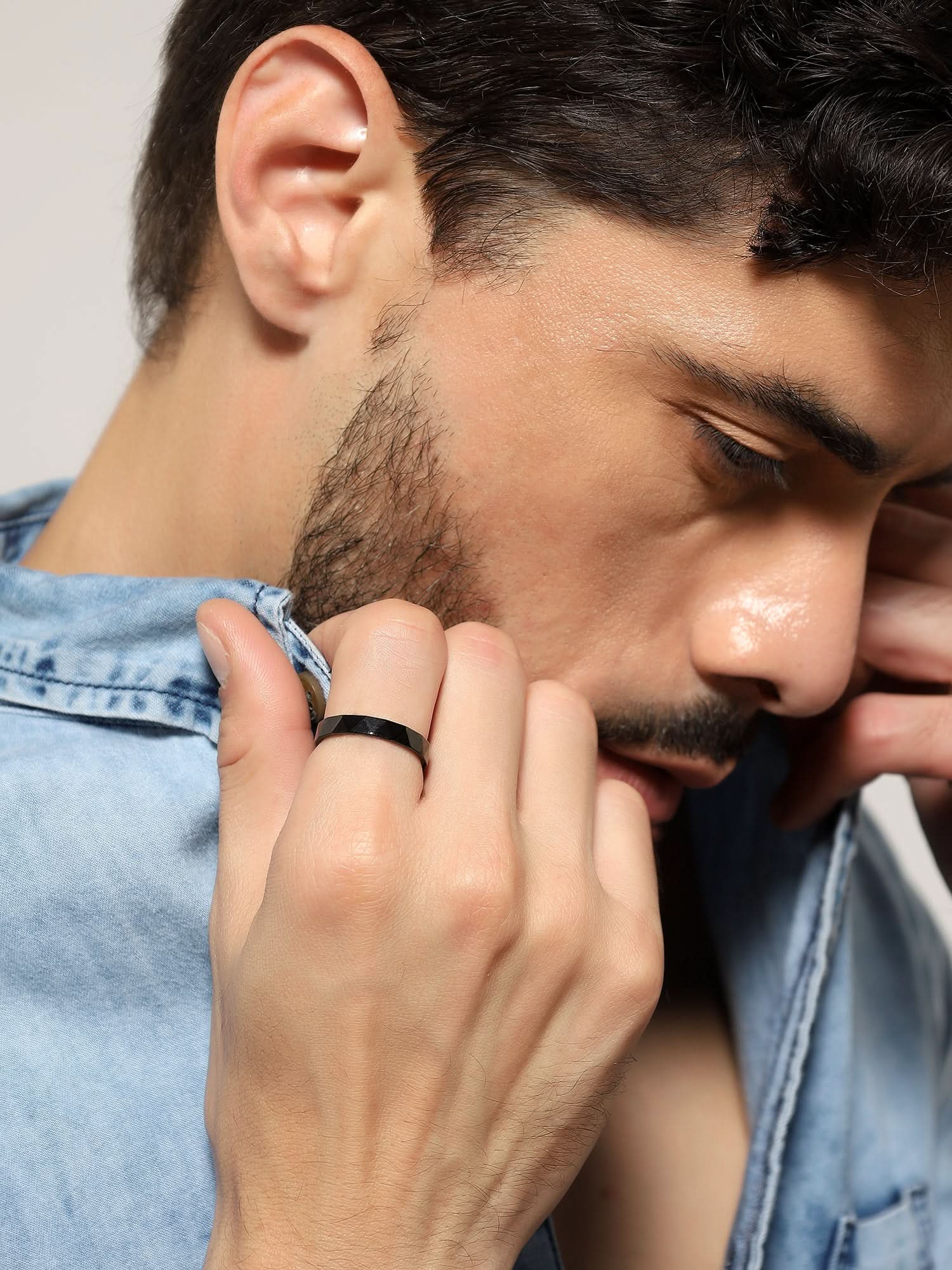 Model wearing Cross Versatile Ring in black — men's black ring styled on hand