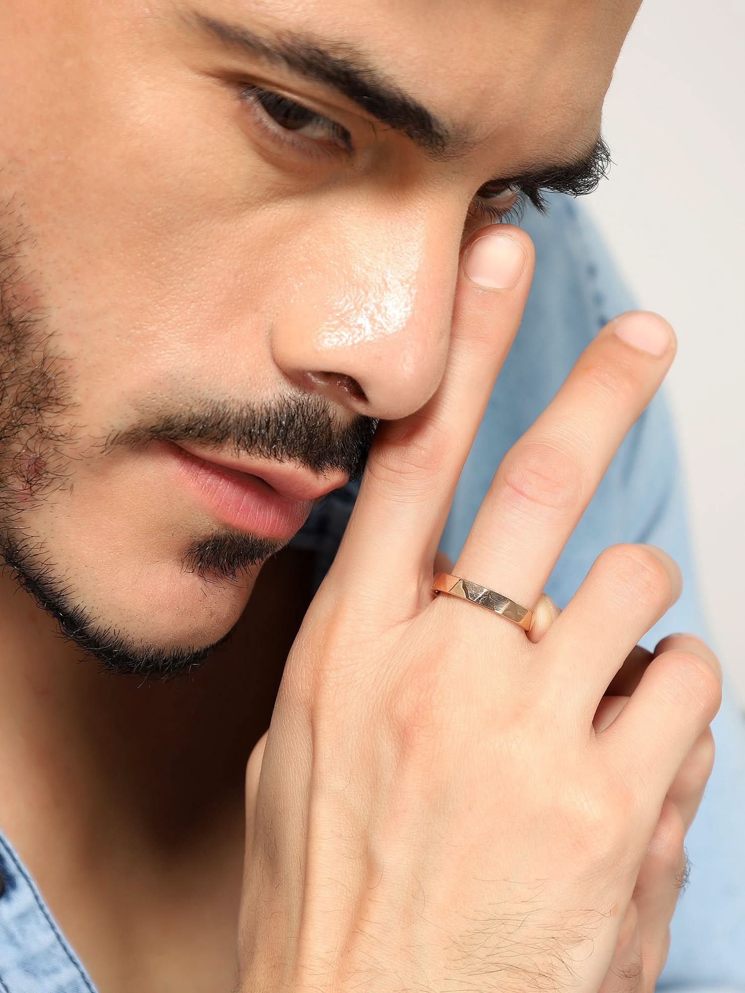 Model wearing Cross Versatile Ring in rose gold — men's rose gold ring styled on hand