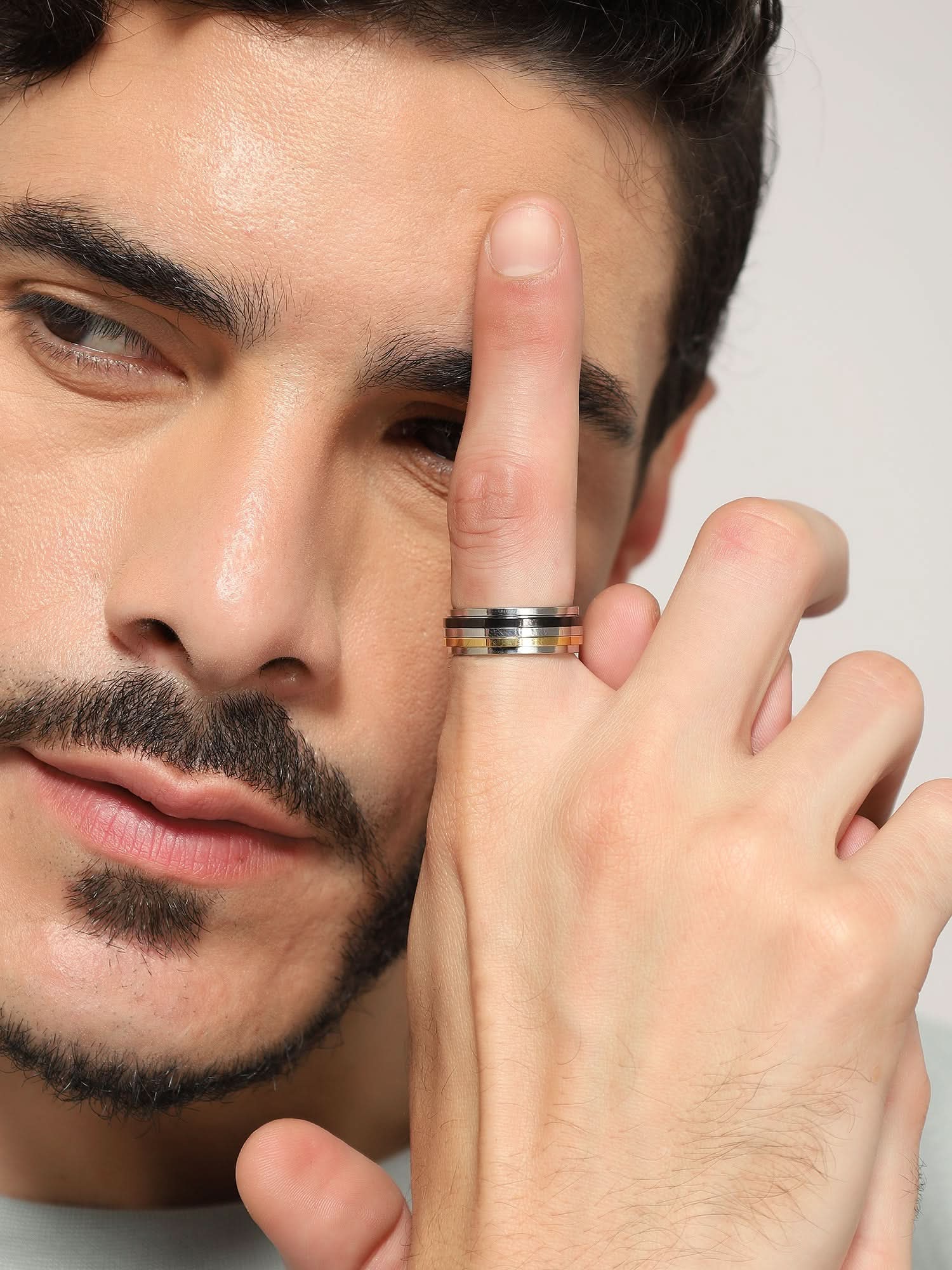 Model wearing Regal Crest Signet Ring in gold — men's gold ring styled on hand