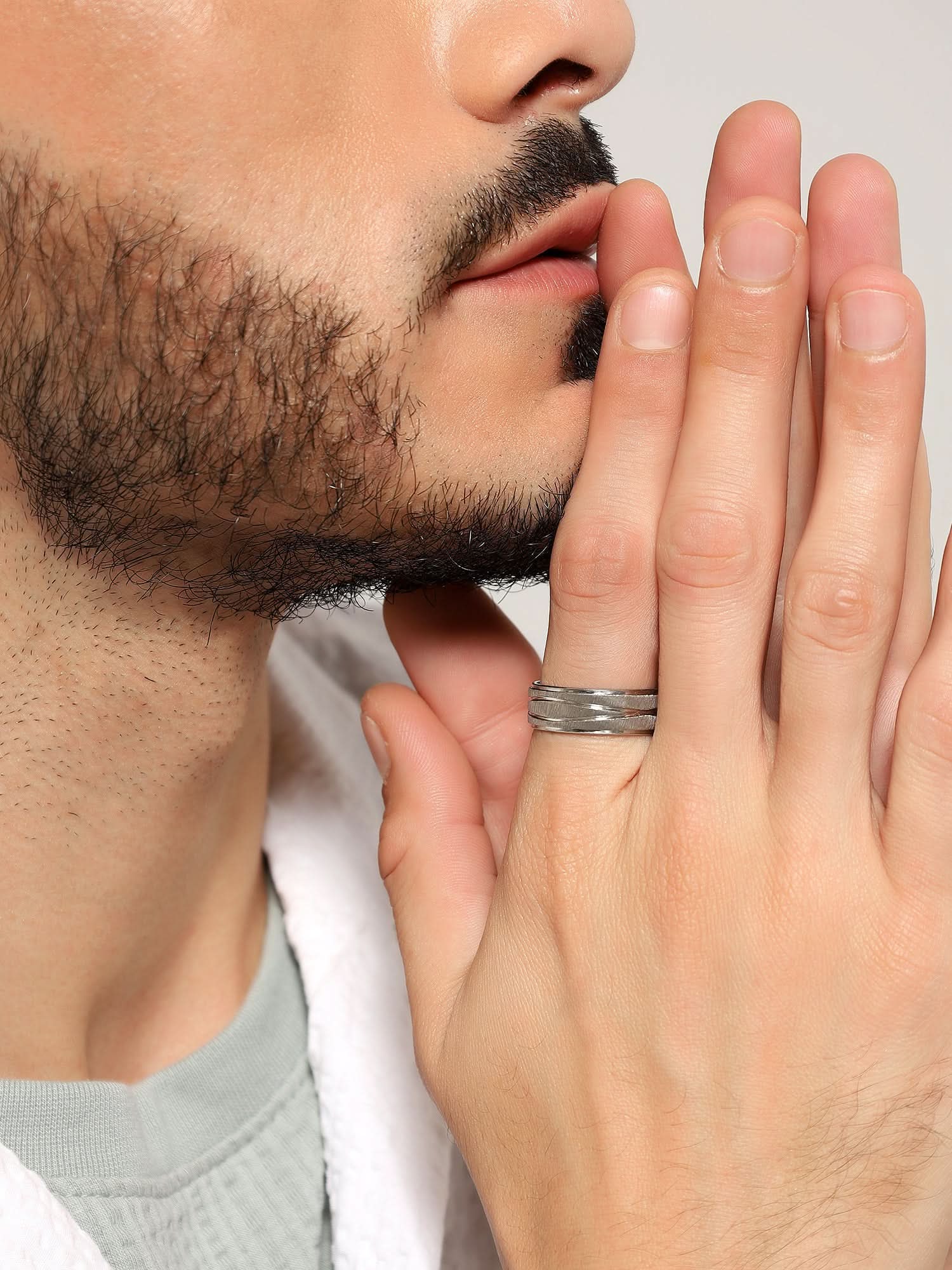 Model wearing Crossover Line Ring in silver — men's silver ring styled on hand