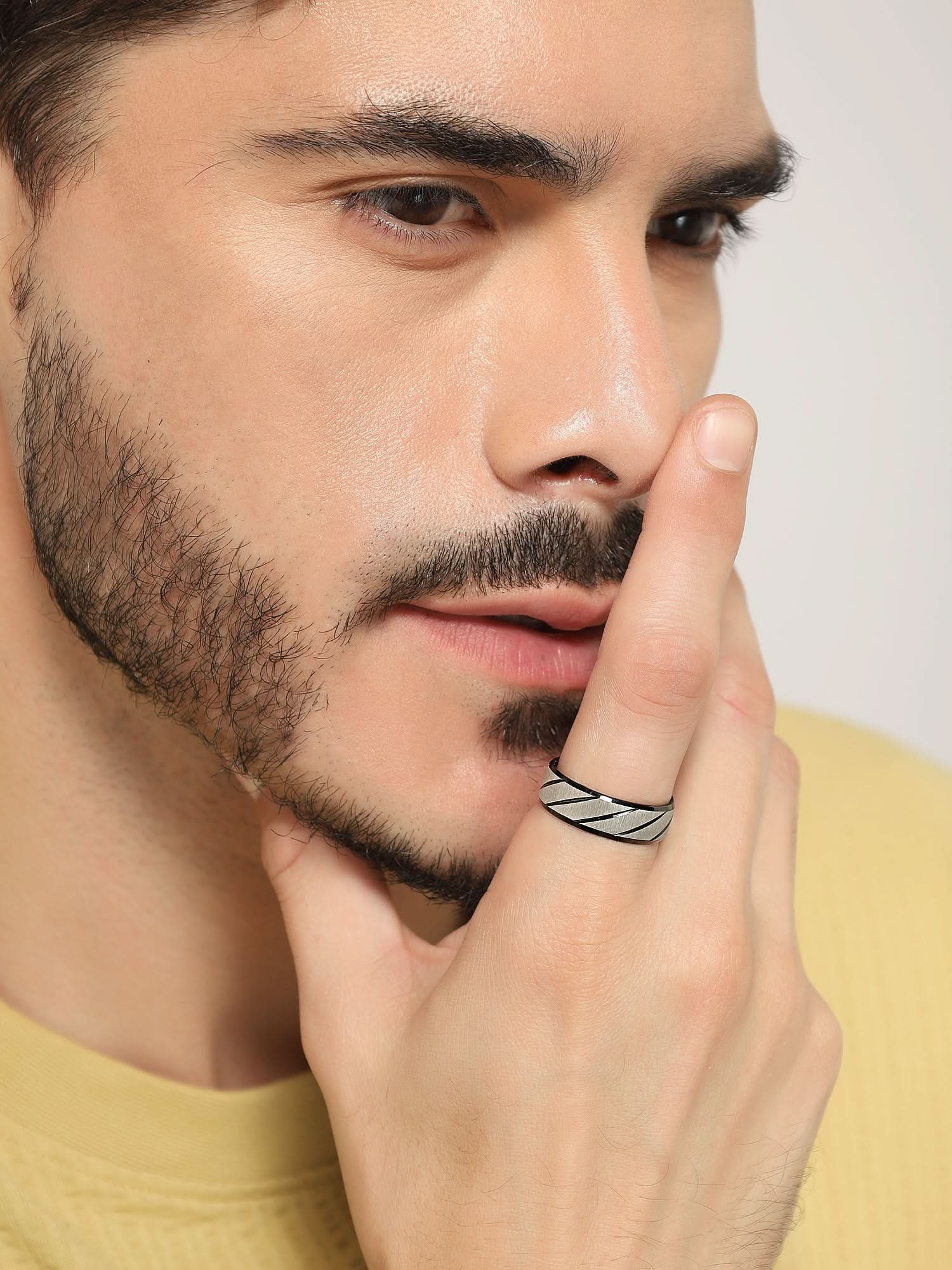 Model wearing Frosted Wave Carved Knuckle Ring in black — men's black ring styled on hand