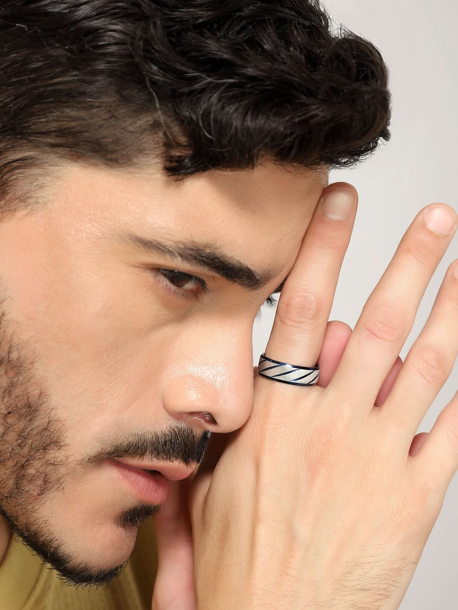 Model wearing Frosted Wave Carved Knuckle Ring in blue — men's blue ring styled on hand