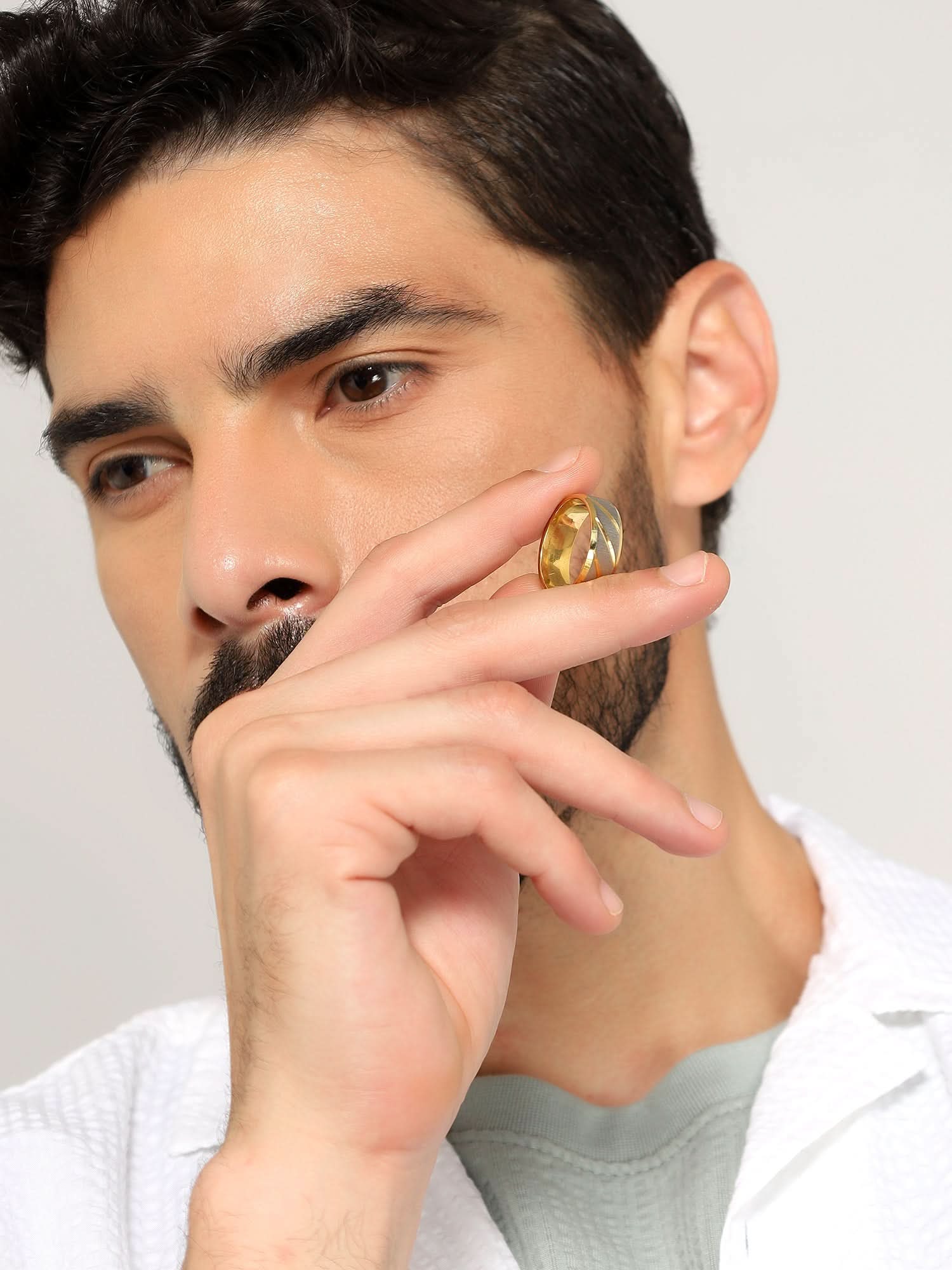 Model wearing Frosted Wave Carved Knuckle Ring in gold — men's gold ring styled on hand