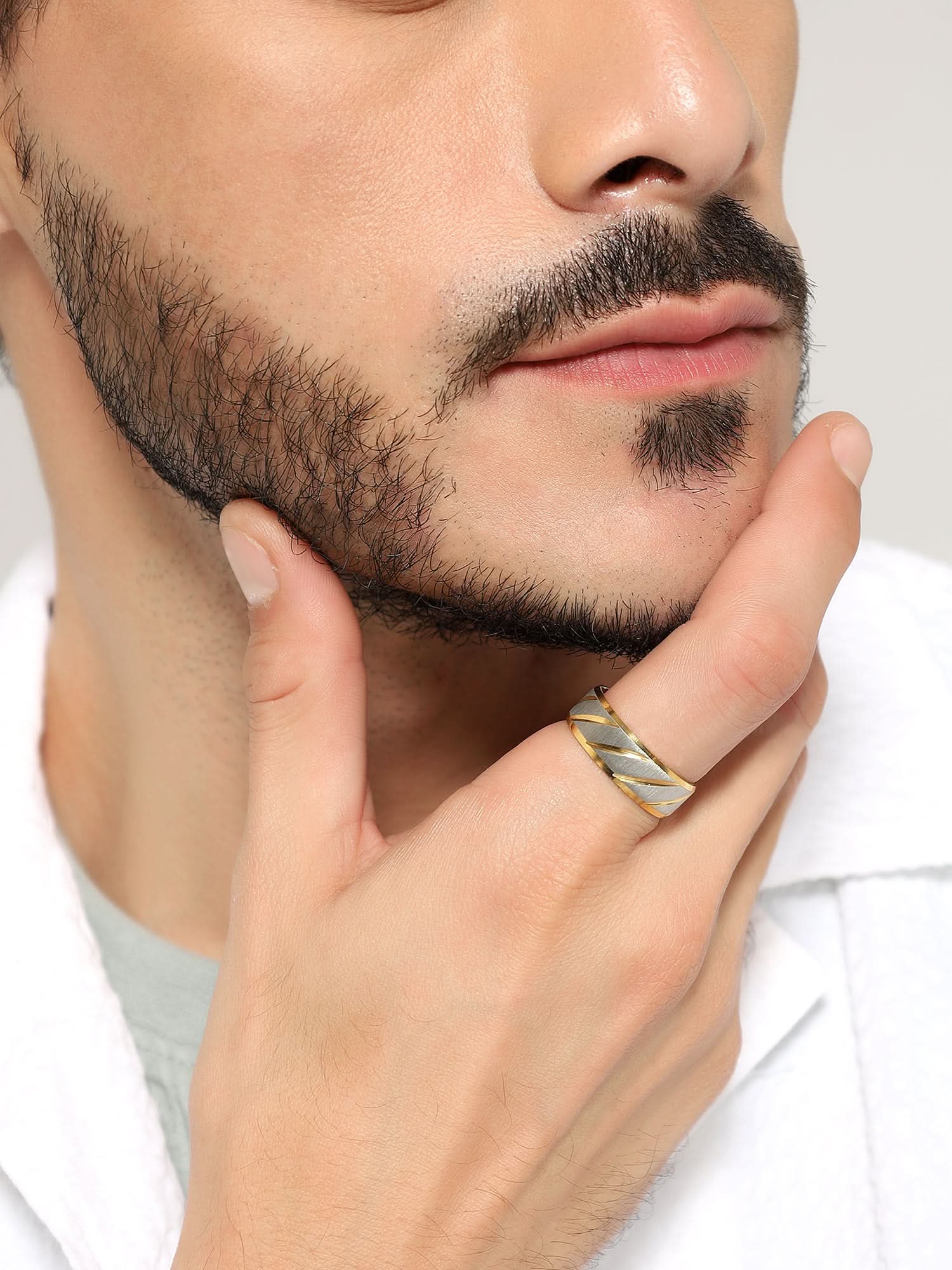 Model wearing Frosted Wave Carved Knuckle Ring in gold — men's gold ring styled on hand