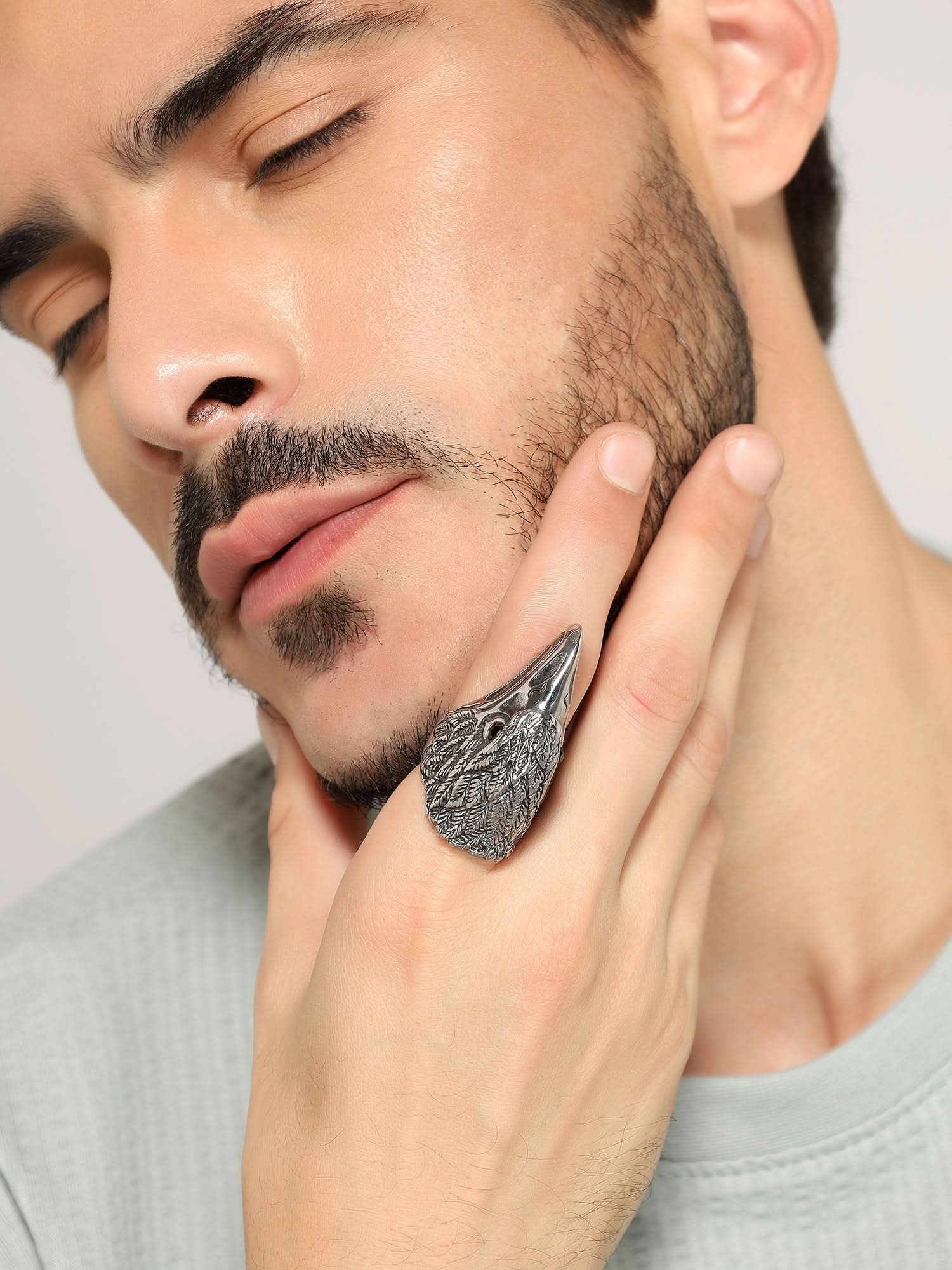 Model wearing Retro Punk Eagle Ring in silver — men's silver ring styled on hand