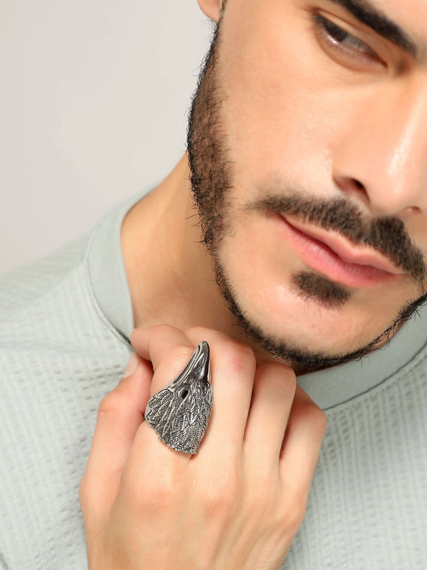 Model wearing Retro Punk Eagle Ring in silver — men's silver ring styled on hand