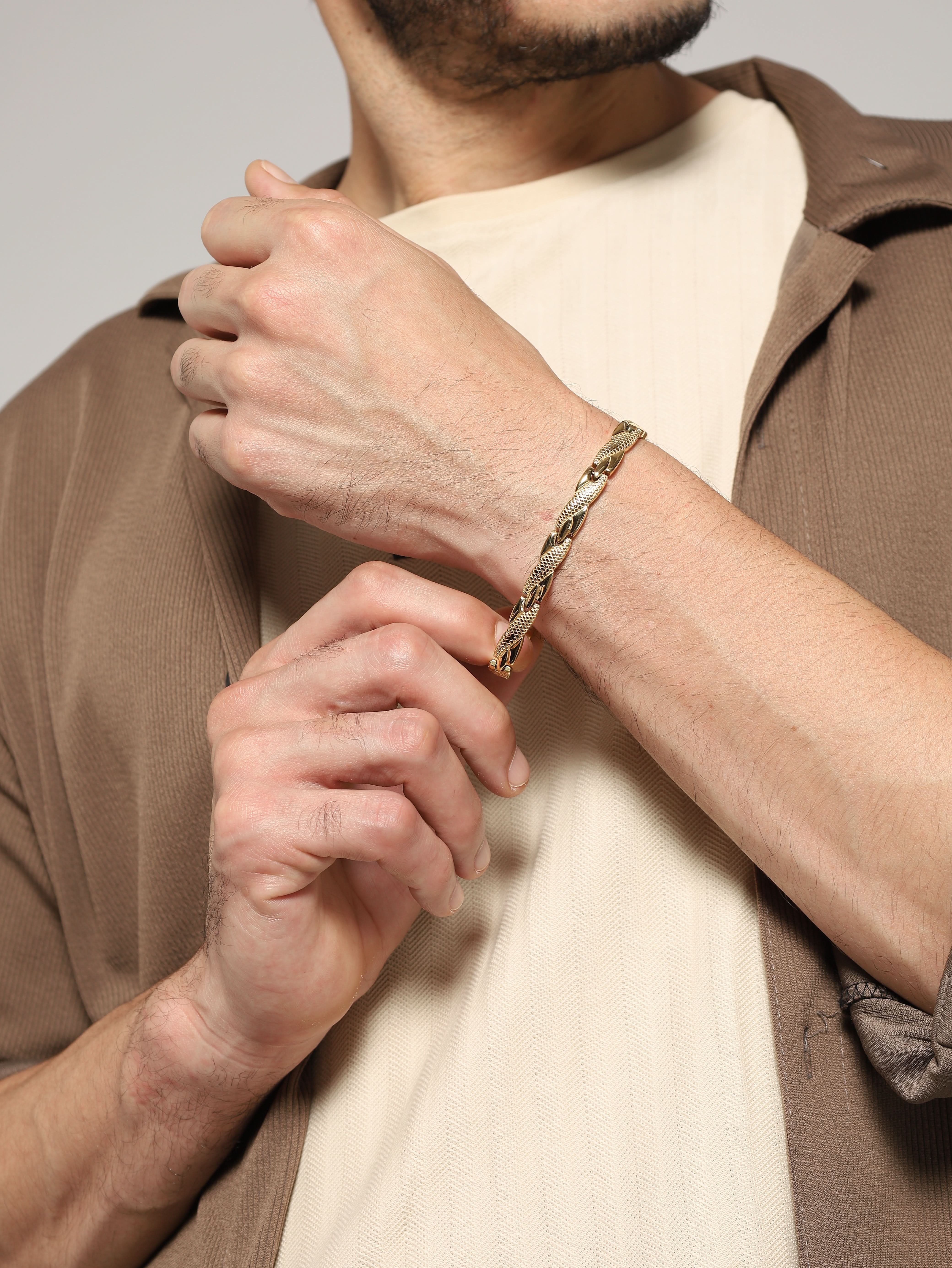 Side view of Jewelor gold magnetic bracelet styled on a man's wrist