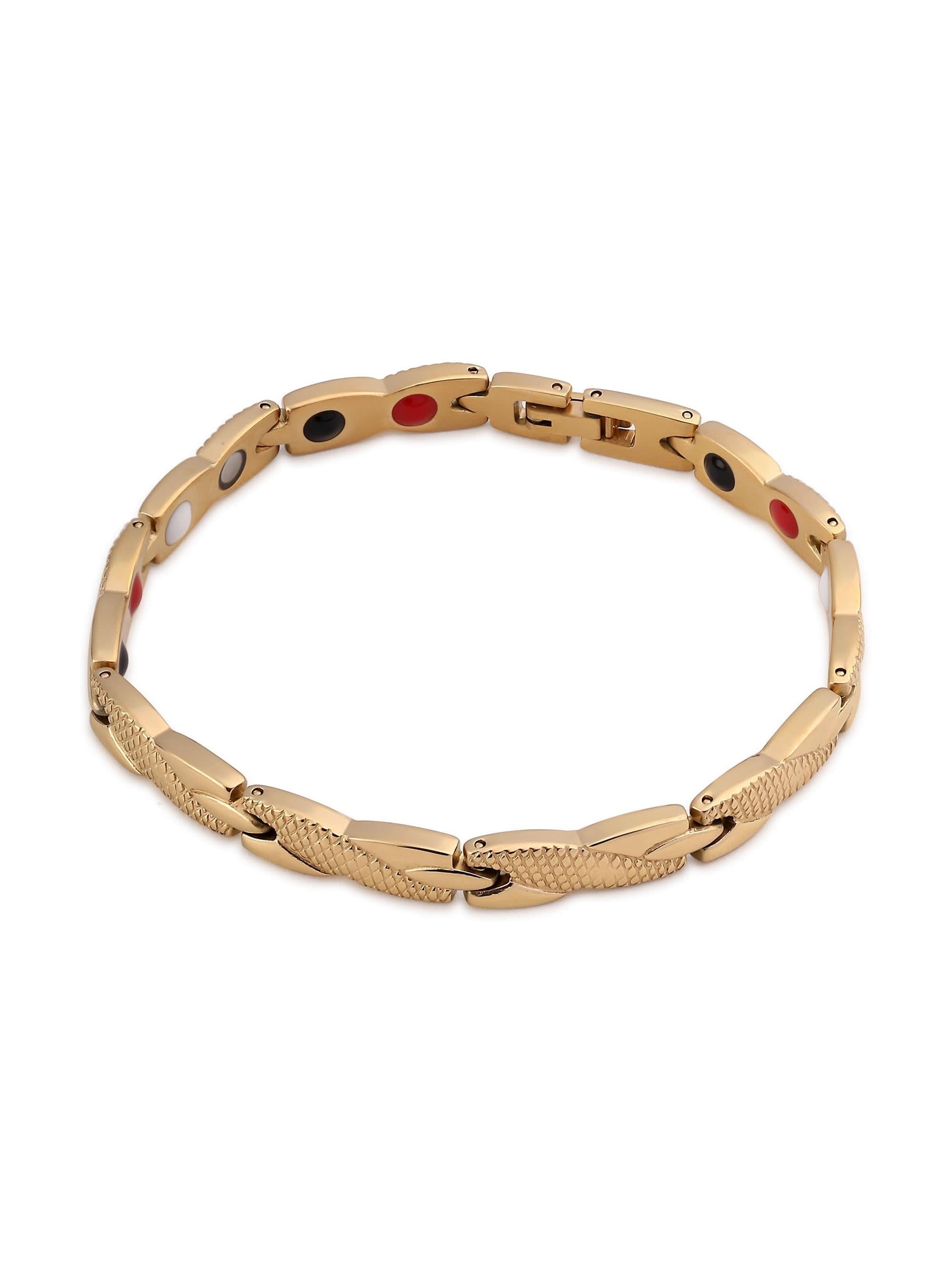 Flat-lay of gold magnetic bracelet showing twisted X-link, magnet inserts, and fold-over clasp