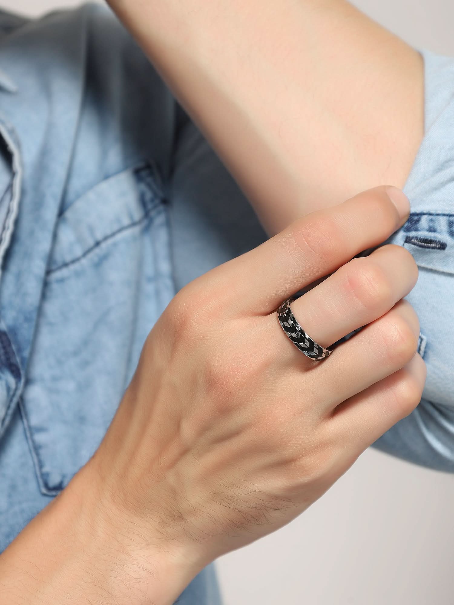 Model wearing Tyre Pattern Ring in silver — men's silver ring styled on hand