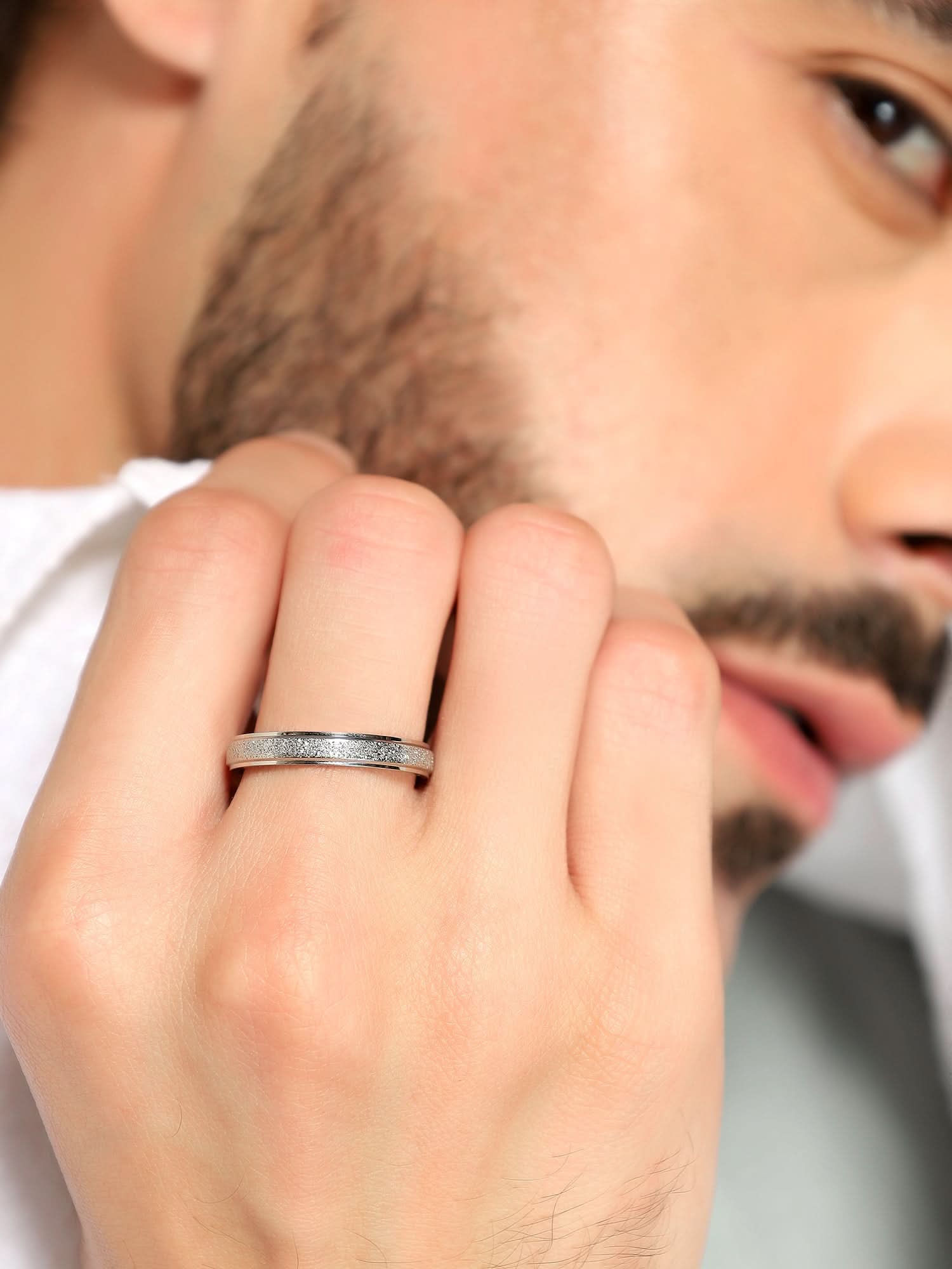 Model wearing Glitty Trose Embossed Ring in silver — men's silver ring styled on hand